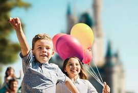 Kids with balloons at Walt Disney World's Magic Kingdom Park