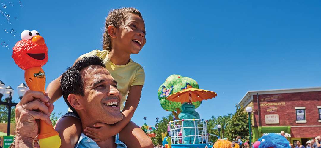 Sesame Street Land A father and child enjoying the Sesame Street character parade