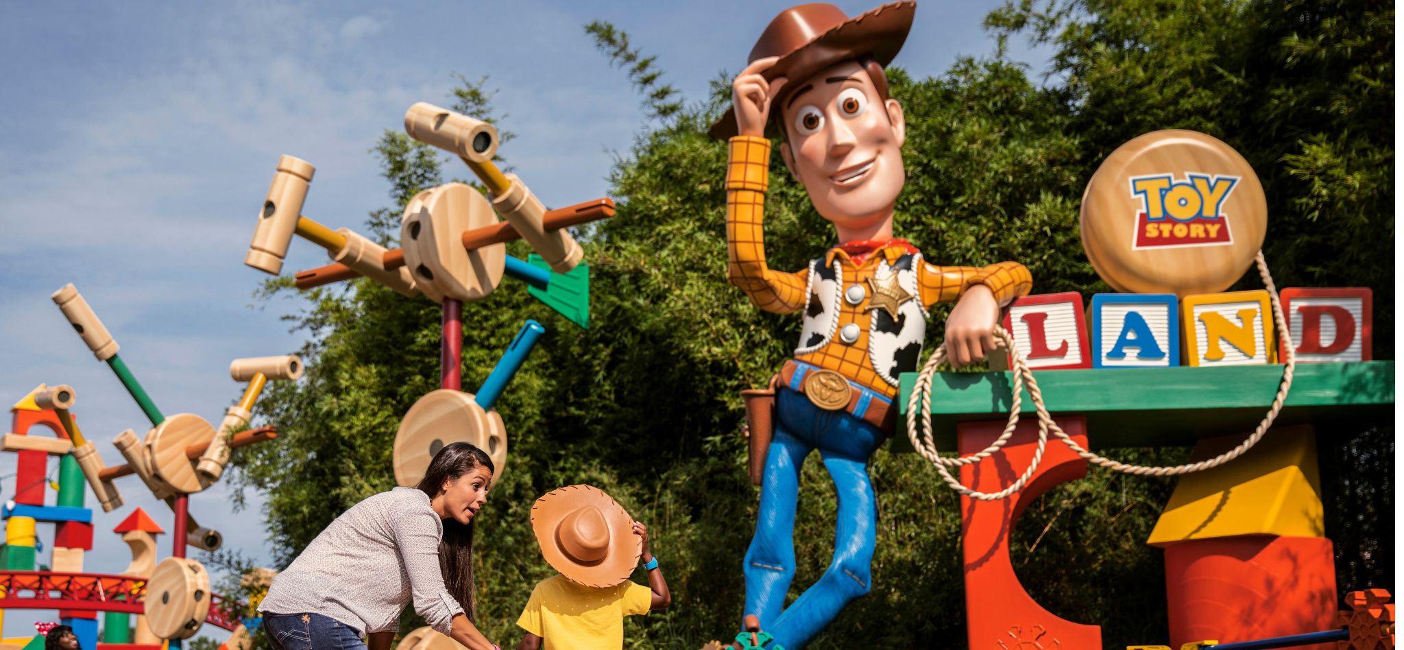 Disney's Hollywood Studios® Toy Story Woody Mom and child in front of Toy Story Woody at Disney's Hollywood Studios®
