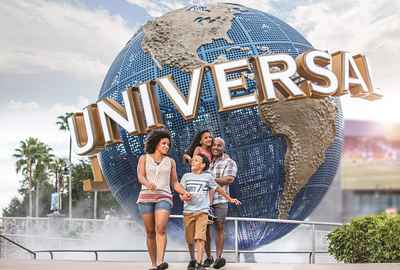 A family walking past the Universal globe in front of Universal Studios Florida