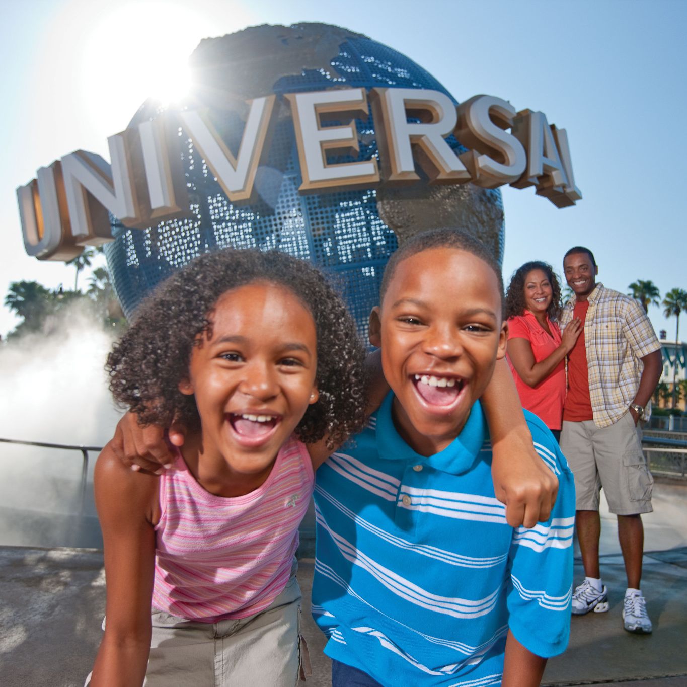 Family posing for a photo in front of the famous globe at Universal Orlando Resort.