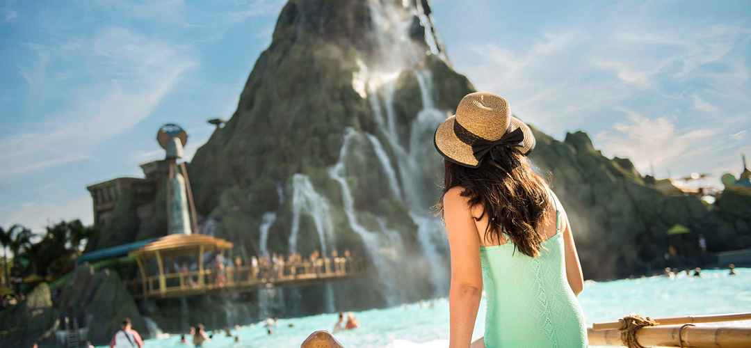 Waturi Beach at Universal's Volcano Bay A young girl sitting on the shore of Waturi Beach at Universal's Volcano Bay.