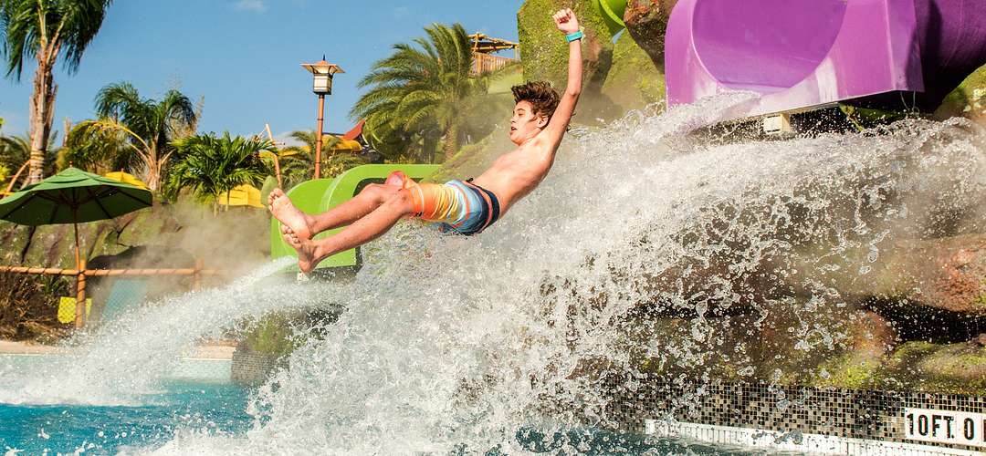 Ohno Ohya slide at Universal's Volcano Bay A kid dropping into a pool from the Ohno Ohya slide