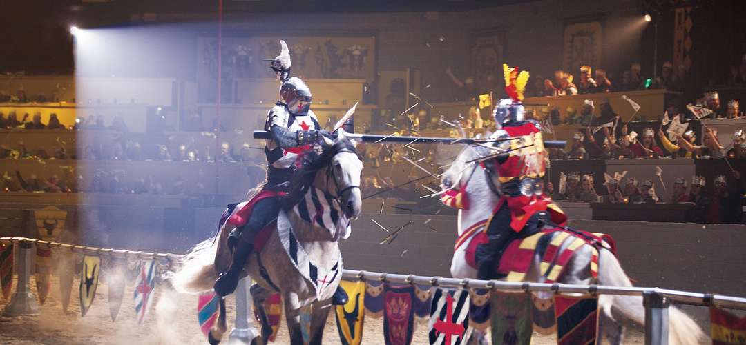 Medieval Times Dinner & Tournament Lances shatter as two knights meet at a jousting tournament