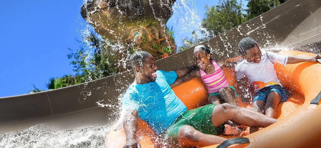 Miss Adventure Falls at Disney's Typhoon Lagoon Family aboard a raft on Miss Adventure Falls at Disney's Typhoon Lagoon Water Park