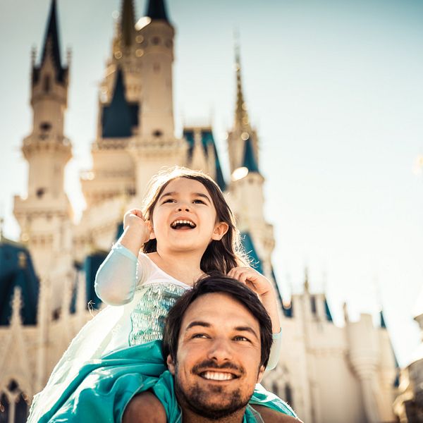 Father and daughter in front of Cinderella Castle at Disney's Magic Kingdom Park