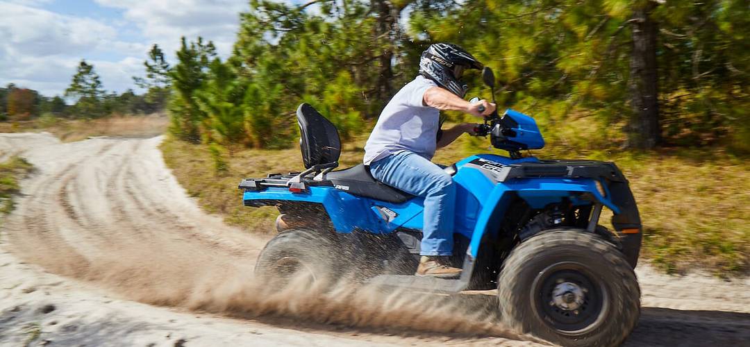 Revolution off-road Man driving an ATV on a dirt path, surrounded by pine trees, near Orlando