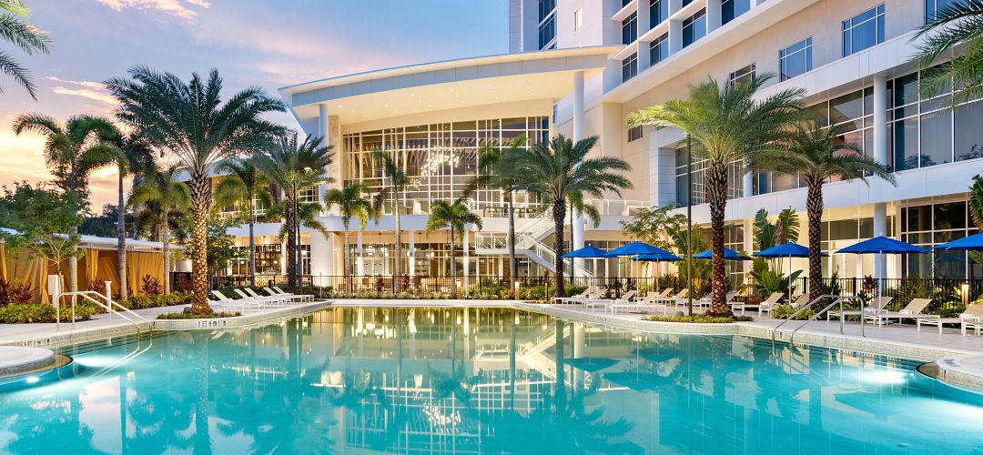 JW Marriott Orlando Bonnet Creek Resort & Spa pool A daytime view of the pool and palm trees with the JW Marriott Orlando Bonnet Creek hotel in the background