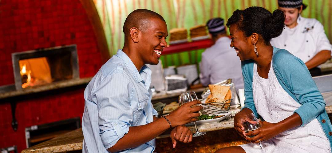 The Cooking Place at Disney's Animal Kindom Lodge Couple laughing while dining at The Cooking Place in Animal Kindgom's Lodge