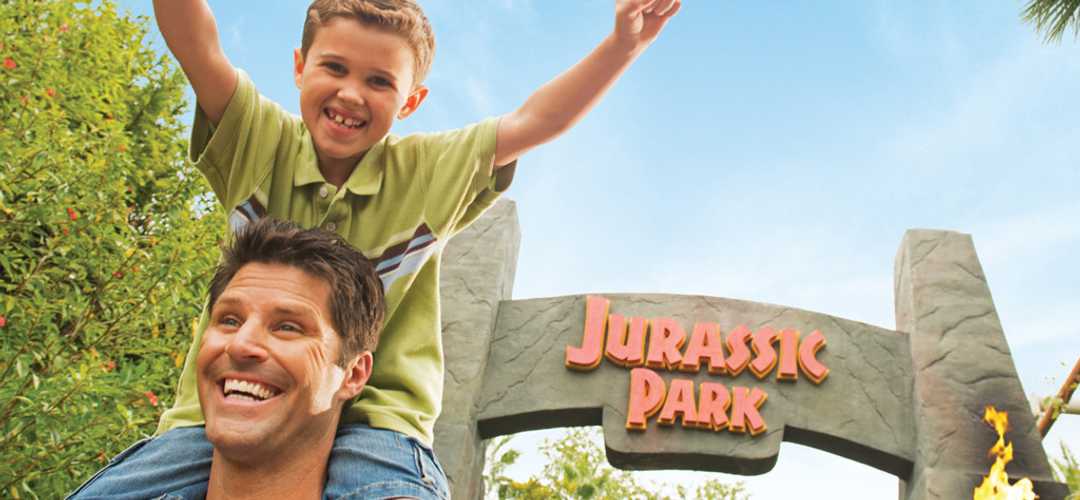 Jurassic Park at Islands of Adventure Excited boy riding on his father's shoulders in Jurassic Park at Islands of Adventure.