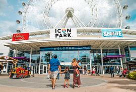 Family in front of The Wheel at ICON Park