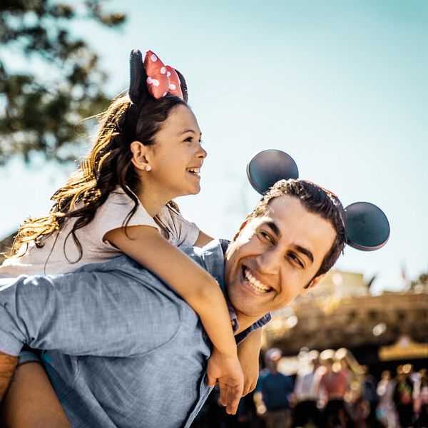 Father giving daughter a piggy back ride at the Walt Disney World Resort