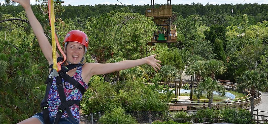 Zip line at Gatorland A woman riding a zipline from one tower to another at Gatorland in Orlando