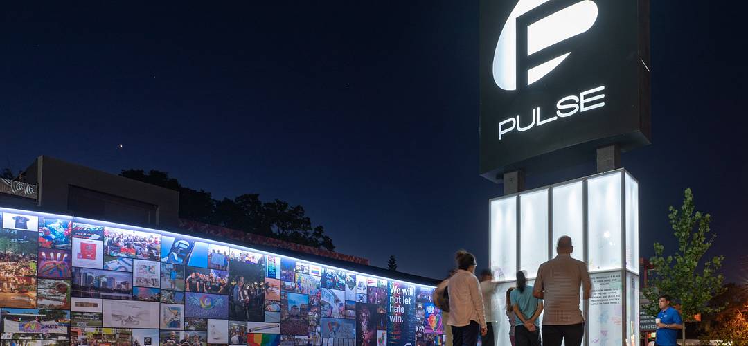 Pulse Nightclub Memorial Nighttime view and row of photos at the Pulse Nightclub Memorial