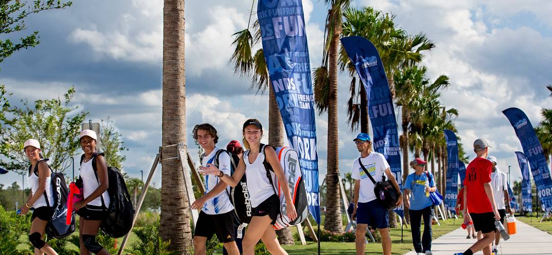 USTA Welcome Center A group of tennis students walking towards the USTA Welcome Center, The Home of American Tennis® in Orlando, Florida.
