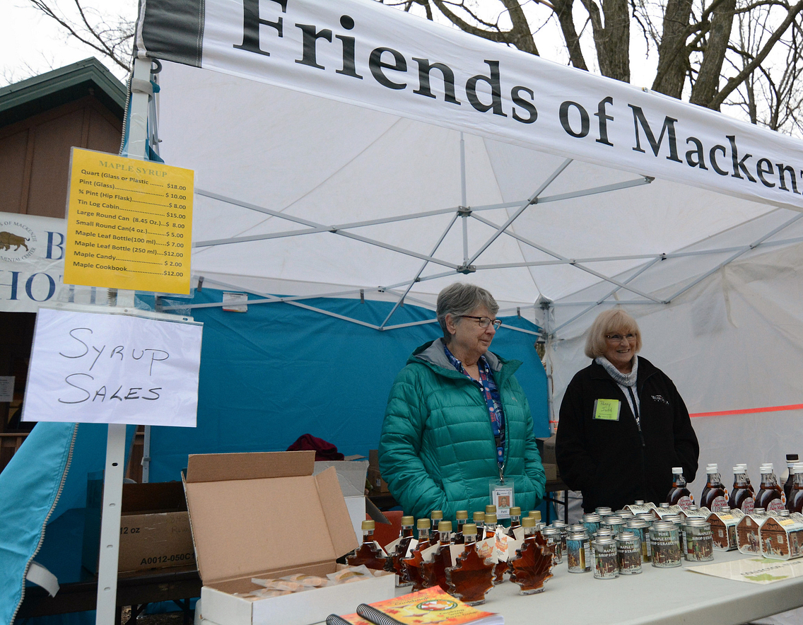 Friends of MacKenzie Center selling syrup at Maple Syrup Festival