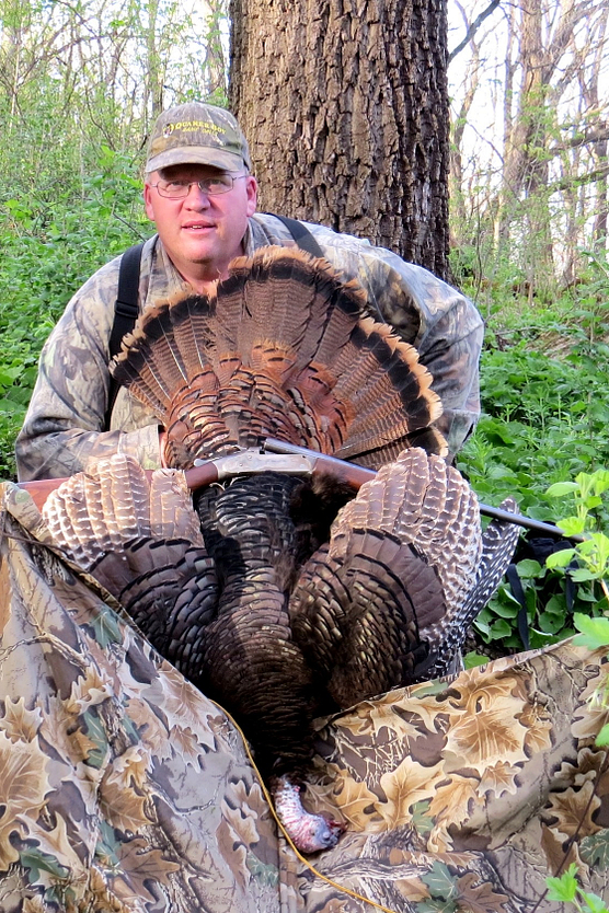 Hunter posing with turkey he shot with a .410-gauge shotgun