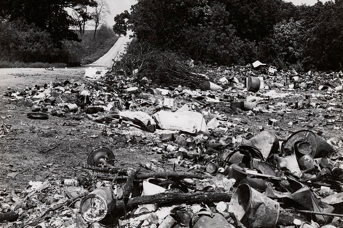 historic photo of a garbage dump near a winding road