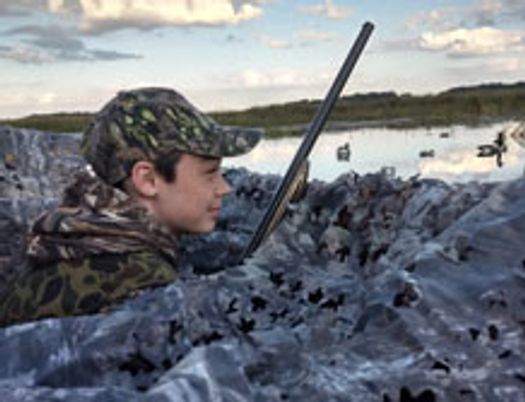 teen boy near a marsh during a morning waterfowl hunt