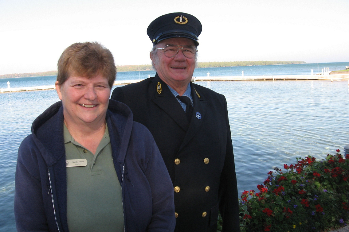 Woman and man, who is in uniform, standing with Lake Michigan in background