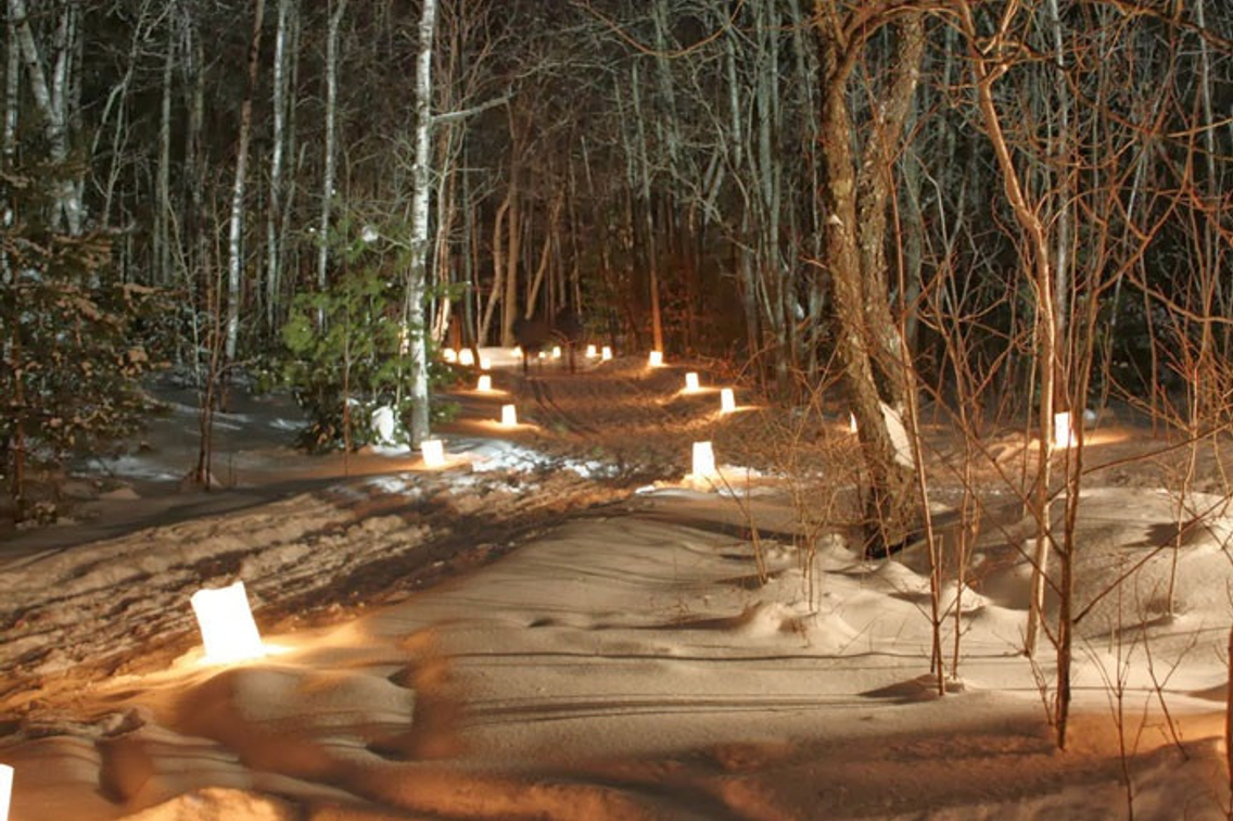 Candles in snow along trail at state park