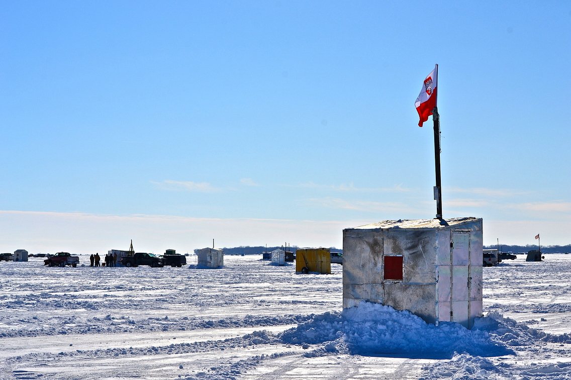 Ice fishing shanties on frozen lake