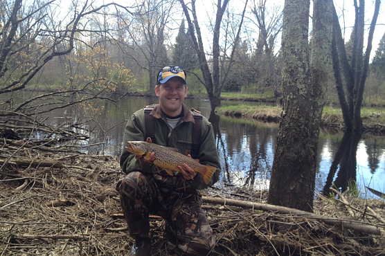 Photo of a man holding a trophy brown trout