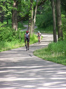 two bicyclists on winding paved trail
