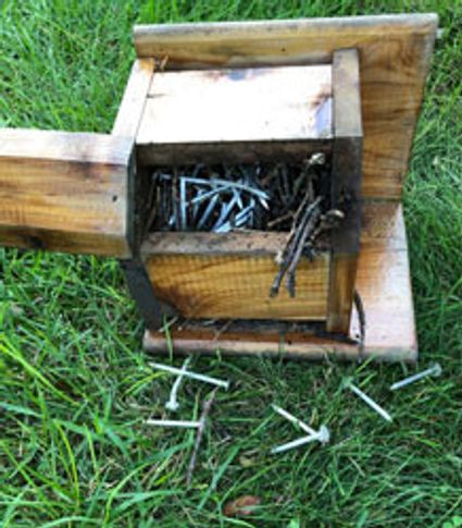 bird box open to find nest made of many nails