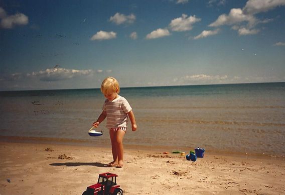 toddler boy on sandy beach in summer
