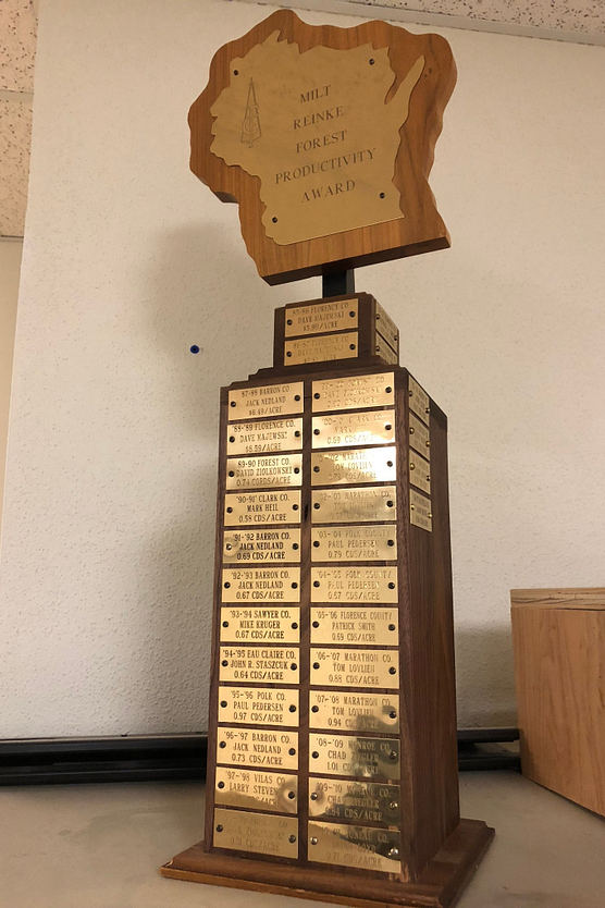 Trophy with state of Wisconsin cutout on top and gold plates down the front