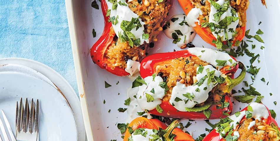 Bulgur-Stuffed Bell Peppers with Garlic Sauce served in a casserole dish