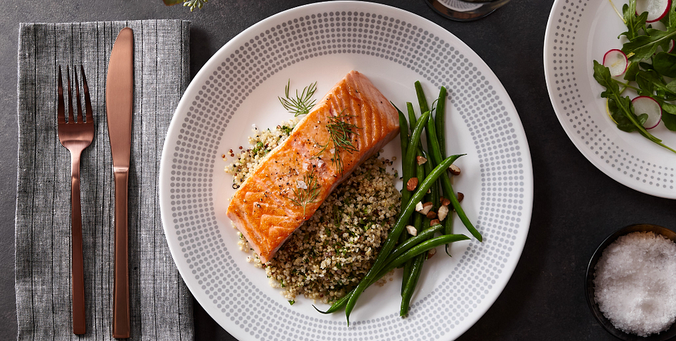 Bayside Dots Gray pattern corelle plates with salmon plated on top of wild rice with green beans.
