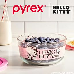 4-cup Round Glass Storage: Hello Kitty®, Pink with blueberries inside the dish and a glass beside it on the counter
