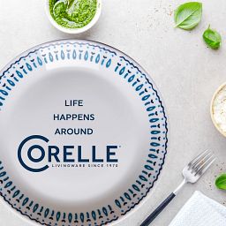 Glass Azure Medallion 7.5" Salad Plate on table with text Life Happens around Corelle