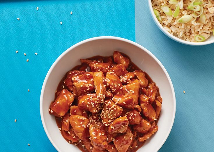 Sesame Chicken in bowl with chopsticks and rice