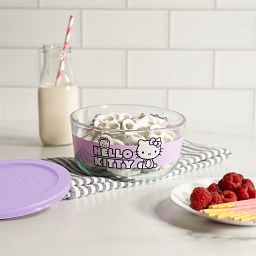 Hello Kitty  purple 4-cup Round Glass storage with food inside and a glass of milk on the side; on the counter