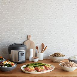 Instant Zest 8-cup Rice and Grain Cooker on counter with salmon and other foods on the counter
