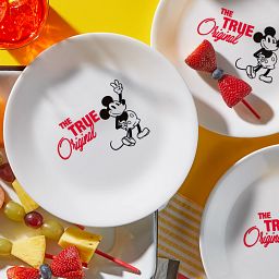 8.5" Salad Plate: Mickey Mouse™ - The True Original on the table with appetizers