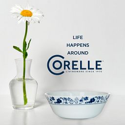 Rutherford 18-oz Cereal Bowl with vase beside with daisy inside and text "life happens around corelle"