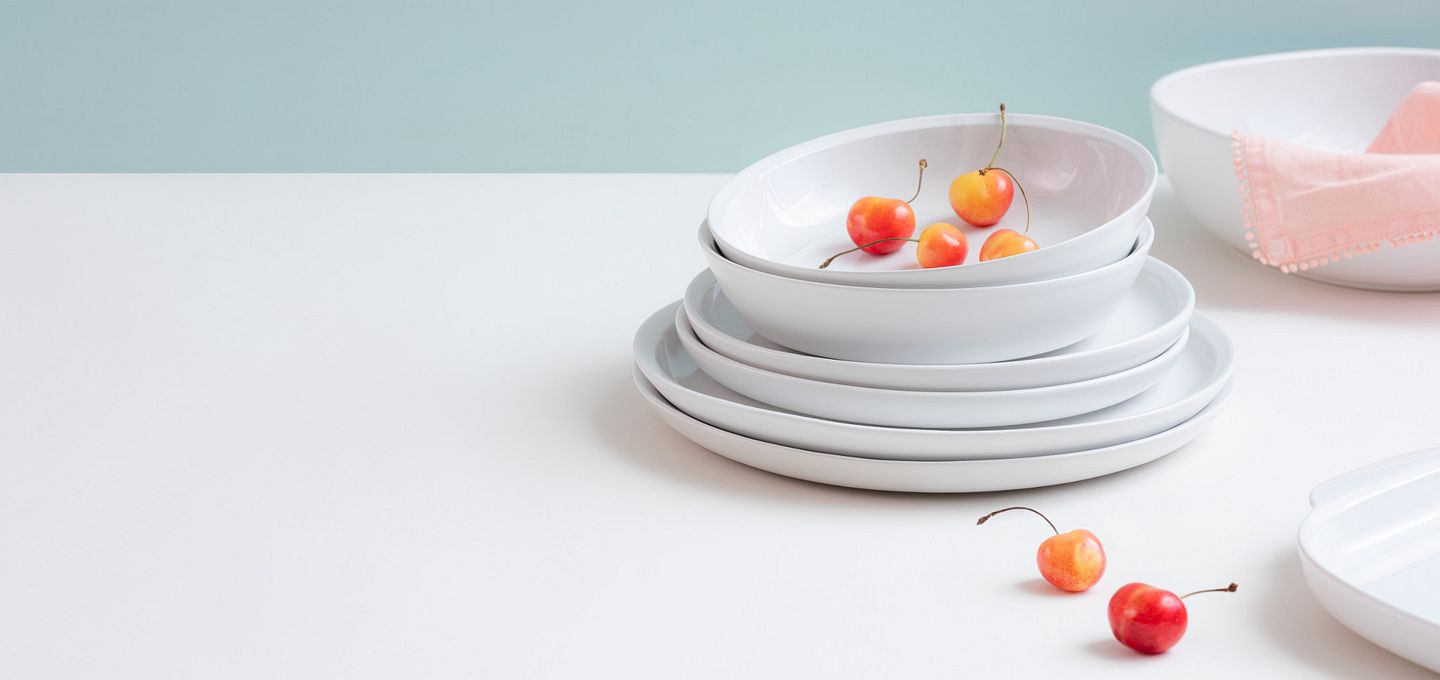 Ivory colored dinnerware by Corningware stacked