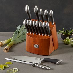 Fusion™ 17-piece Block Set on the counter with chef knife and sharpening steel laying in front of it
