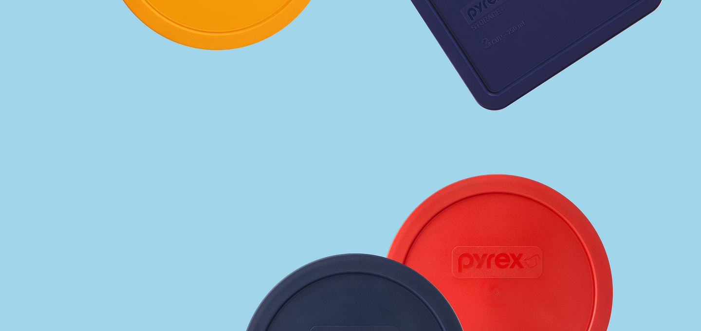 A variety of pyrex lids shown on a blue background