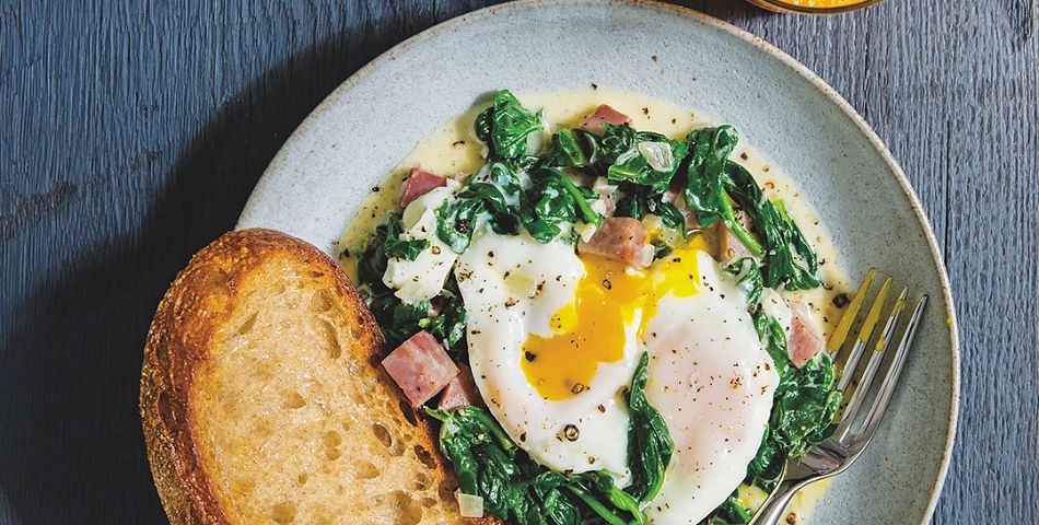 baked eggs with creamy spinach and ham on plate
