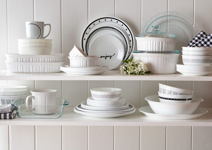 Shelves filled with Corelle plates and Corningware bakeware