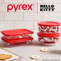 Hello Kitty 8-pc Holiday storage set on the counter with food, text freezer, microwave & dishwasher safe