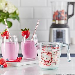 Hello Kitty 2-cup Measuring Cup being used to pour milk into a blender